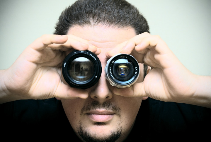 Man looking through lenses